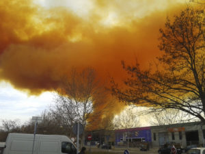 An orange toxic cloud is seen over the town of Igualada, near Barcelona following an explosion in a chemical plant, February 12, 2015. Three people were injured in the explosion at the chemical plant in northern Spain on Thursday and authorities advised residents of several small towns near Barcelona to stay indoors as the large toxic cloud spread over the area. Catalan authorities told people to shut their windows and stay inside as a precaution, and cut off some roads in the area as well as a train line. REUTERS/Paula Arias