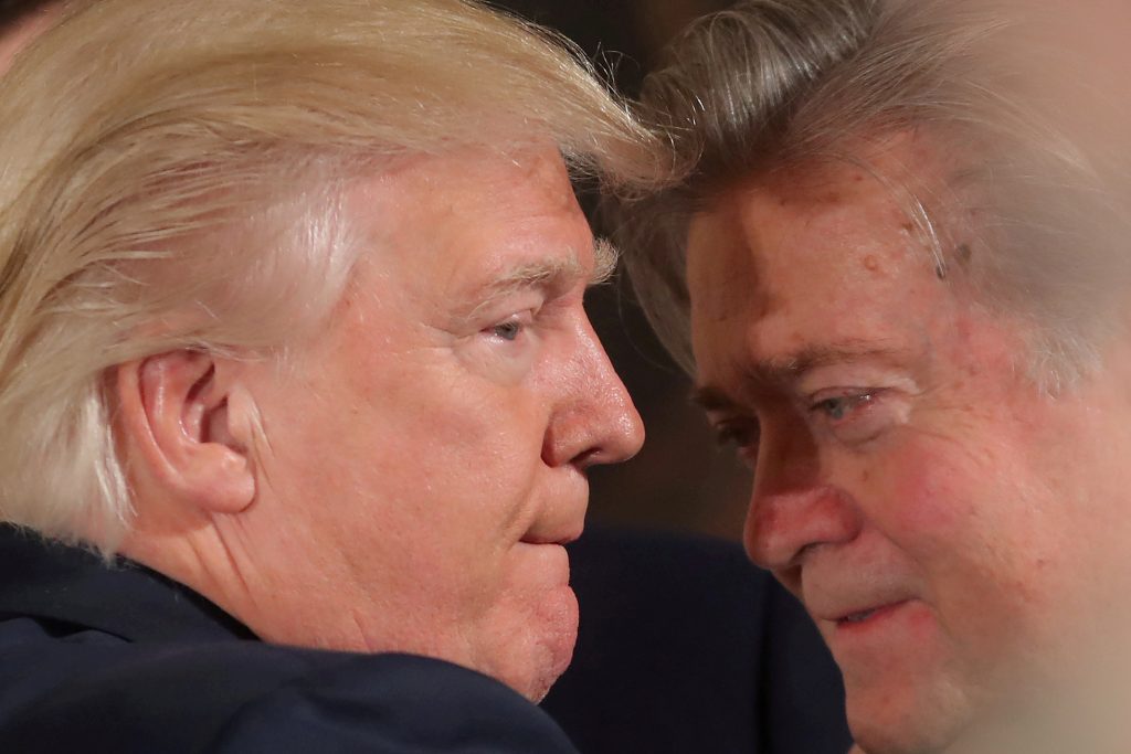FILE PHOTO: U.S. President Donald Trump talks to chief strategist Steve Bannon during a swearing in ceremony for senior st...