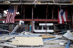 U.S. and Puerto Rico flags hang on a damaged church after the area was hit by Hurricane Maria in Carolina