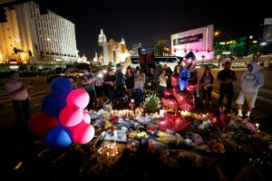 People gather at a makeshift memorial in the middle of Las Vegas Boulevard following the mass shooting in Las Vegas, Nevada. Photo by Chris Wattie/REUTERS