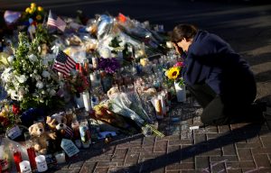 A woman pauses at a makeshift memorial in the middle of Las Vegas Boulevard following the mass shooting in Las Vegas last October. Photo by Reuters.