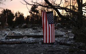 An American flag hangs from a tree in a neighborhood destroyed by wildfire in Santa Rosa, California, U.S., October 12, 2017. Photo by Jim Urquhart/REUTERS