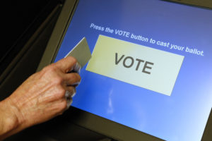 An elections official demonstrates a touch-screen voting machine at the Fairfax County Governmental Center in Fairfax, Virginia. Photo by Jonathan Ernst/Reuters