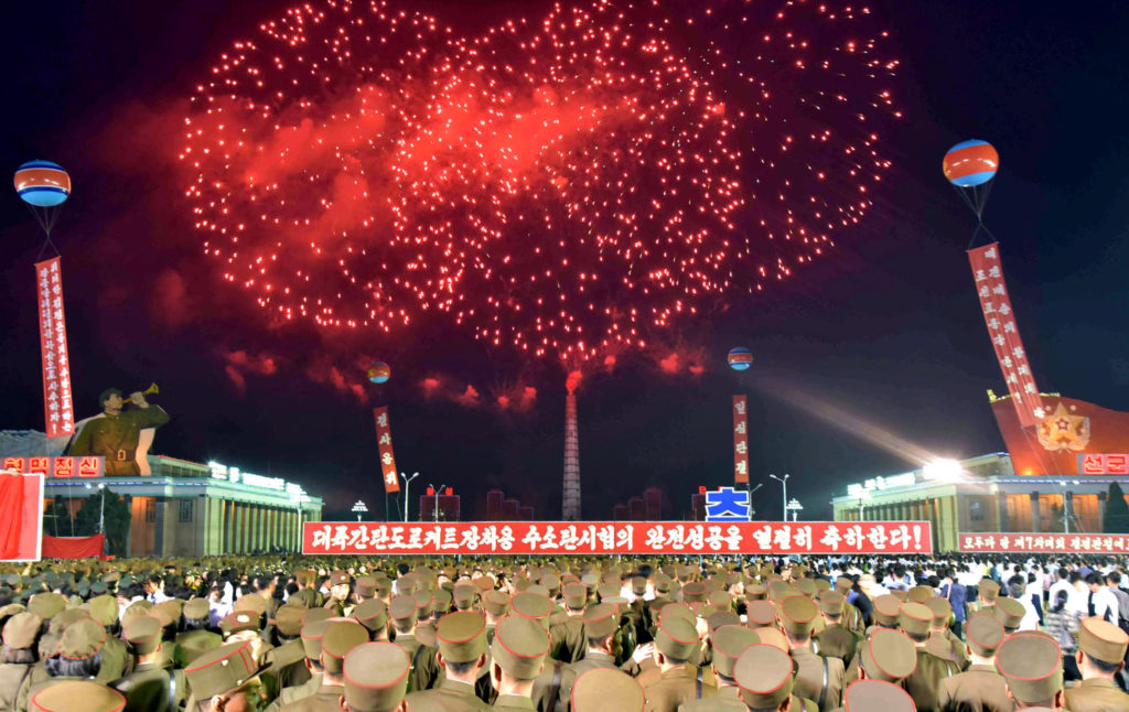 Pyongyang city civilians celebrate the successful completion of the hydrostatic test for the intercontinental ballistic ro...