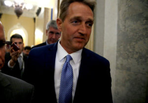U.S. Senator Jeff Flake (R-AZ) walks past journalists after announcing he will not run for reelection on Capitol Hill in Washington, DC, U.S. October 24, 2017. REUTERS/Joshua Roberts - RC115CA83EE0