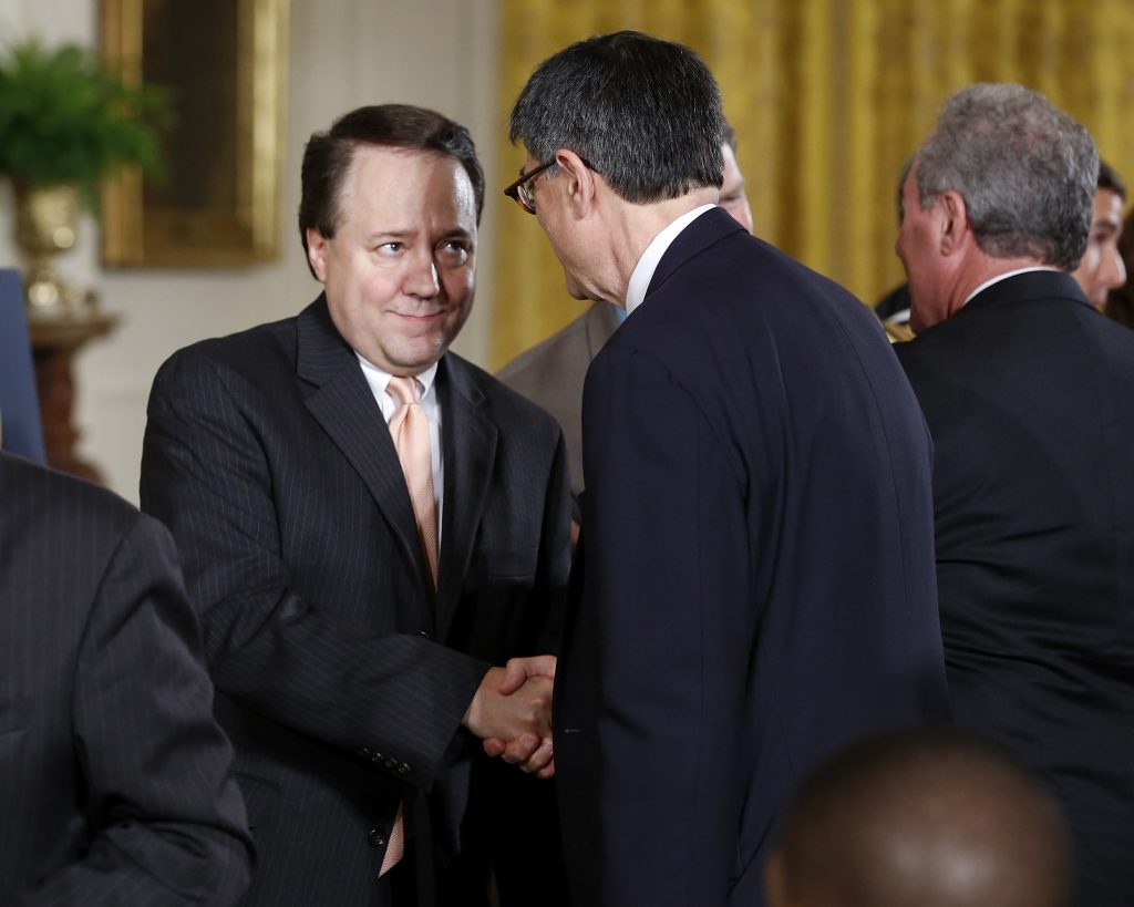 U.S. Treasury Secretary Jack Lew (2nd R, back to camera) shakes hands with U.S. House members who supported trade legislat...