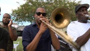 Trombone Shorty joins a 'second line' in New Orleans. Credit: Jason Lelchuk