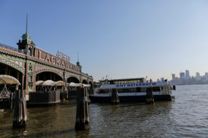 People board the ferry after arriving at the Hoboken Terminal