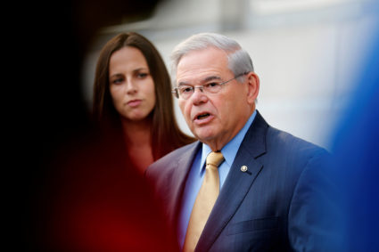 FILE PHOTO: Senator Bob Menendez speaks to journalists after arriving to face trial for federal corruption charges as his daughter Alicia Menendez looks on outside United States District Court for the District of New Jersey in Newark, New Jersey, U.S., September 6, 2017. REUTERS/Joe Penney/File Photo - RC1CBC7DE880
