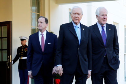 Republican members of the U.S. Senate Finance Committee, including U.S. Pat Toomey (R-PA), Senator Orrin Hatch (R-UT) and Senator John Cornyn (R-TX), walk out to speak to reporters after their meeting about proposed changes in the tax code with U.S. President Donald Trump, at the White House in Washington, U.S. November 27, 2017. REUTERS/Jonathan Ernst - RC11FFBFE400