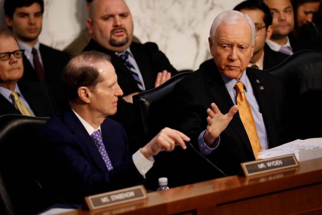 Sen. Orrin Hatch (R-UT) speaks with Sen. Ron Wyden (D-OR) during a markup on the "Tax Cuts and Jobs Act" on Capitol Hill i...