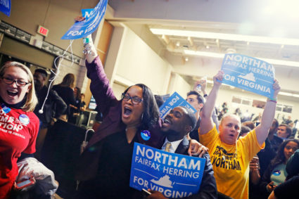 Supporters of Democratic gubernatorial candidate Ralph Northam begin to celebrate as results start to come in at Northam's election night rally on the campus of George Mason University in Fairfax, Virginia, November 7, 2017. REUTERS/Aaron P. Bernstein - HP1EDB805EE05