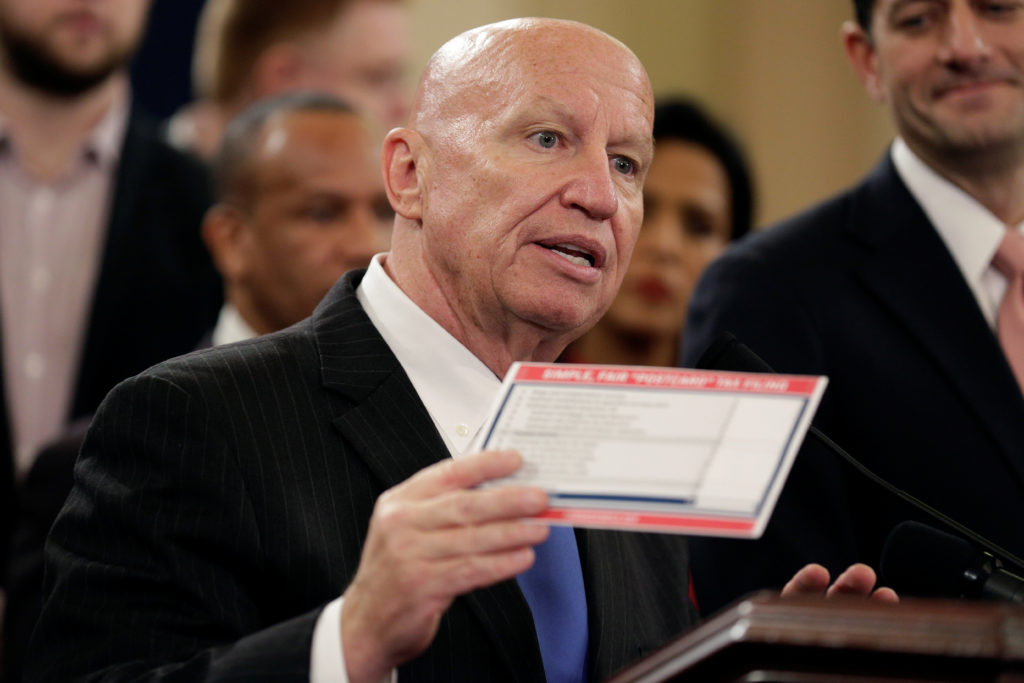 Chairman of the House Ways and Means Committee Kevin Brady (R-TX) holds a sample tax form as he unveils legislation to ove...
