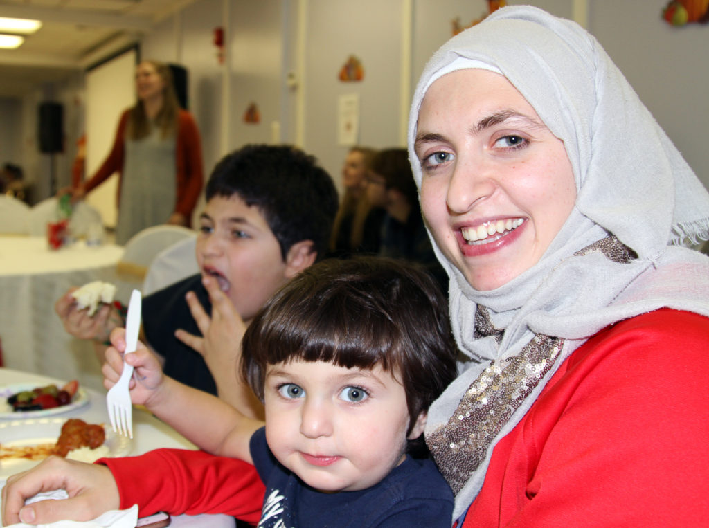 Mays Kalo and her family attend the Refugees’ First Thanksgiving dinner in Arlington, Virginia. Her older son, Farhan, lov...