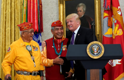 U.S. President Donald Trump hosts an event honouring the Native American code talkers, including Thomas Begay (L) and Peter McDonald, in front of a painting of President Andrew Jackson, at the White House in Washington, U.S., November 27, 2017. REUTERS/Kevin Lamarque - RC16A19016A0