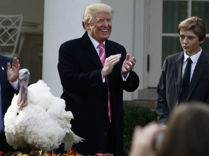 U.S. President Donald Trump laughs and applauds as he participates in the 70th National Thanksgiving turkey pardoning ceremony with his son Barron in the Rose Garden of the White House in Washington, U.S., November 21, 2017. REUTERS/Jim Bourg - HP1EDBL1GHYYZ
