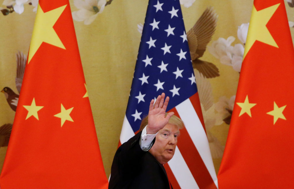 U.S. President Donald Trump waves during joint statements with China's President Xi Jinping at the Great Hall of the Peopl...