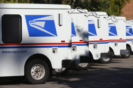 U.S. postal service trucks sit parked at the post office in Del Mar, California November 13, 2013. Photo by Mike Blake/Reuters