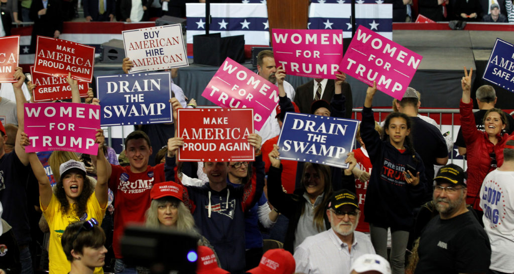 Fans of U.S. President Donald Trump cheer for their president as they wait for his arrival for a rally in Louisville, Kent...