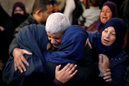 Relatives of a Palestinian man, who was shot dead during clashes with Israeli troops on Friday, mourn during his funeral in Khan Younis in the southern Gaza Strip