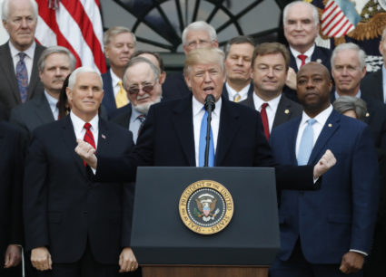 U.S. President Donald Trump speaks flanked by Vice President Mike Pence and Senator Tim Scott (R) as he celebrates with Congressional Republicans after the U.S. Congress passed sweeping tax overhaul legislation, on the South Lawn of the White House in Washington, U.S., December 20, 2017. REUTERS/Jonathan Ernst - HP1EDCK1M7E4C