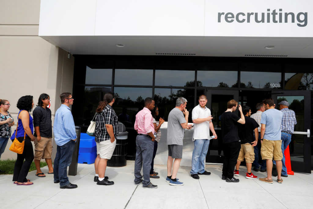 FILE PHOTO: Job seekers line up to apply during "Amazon Jobs Day," a job fair being held at 10 fulfillment centers across ...