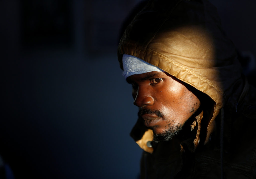 A migrant waits for the MV Aquarius, a search and rescue ship run in partnership between SOS Mediterranee and Medecins San...