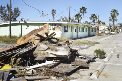 Debris sits outside of a shuttered shopping center on the main street of Fulton, Texas. The Rockport-Fulton Chamber of Commerce estimates only 460 of 1,300 businesses have reopened since Hurricane Harvey. Photo by Gretchen Frazee