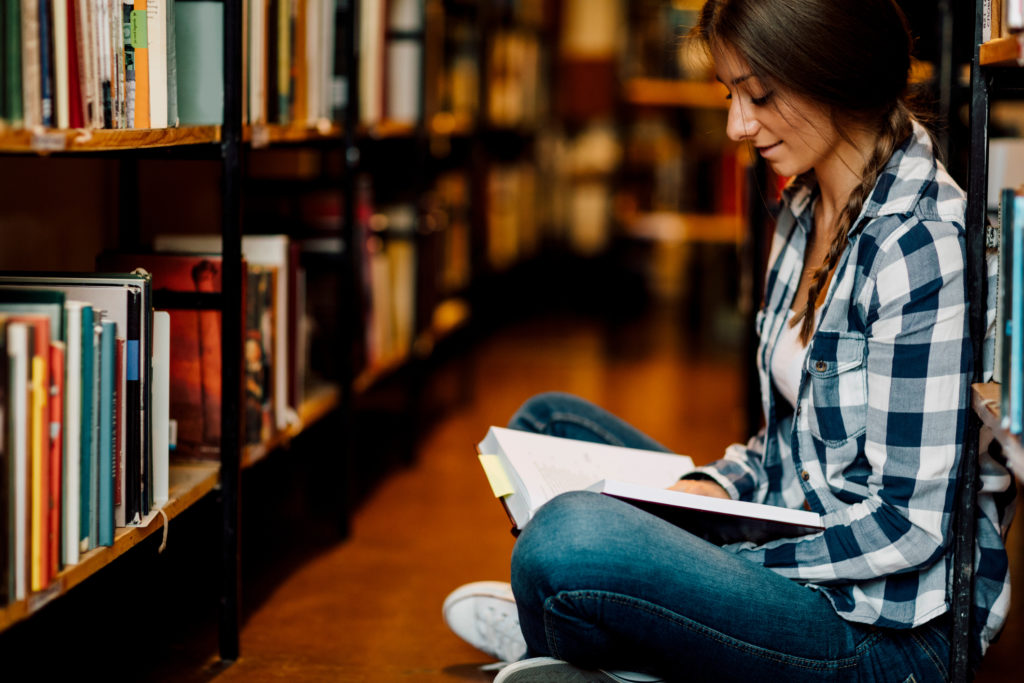 Photo of library bookshelf by vgajic via Getty Images