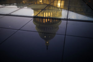 The U.S. Capitol is seen reflected in the windows of the Capitol Visitors Center as lawmakers work to avert a government shutdown January 19, 2018 in Washington, DC. A continuing resolution to fund the government has passed the House of Representatives but faces a stiff challenge in the Senate. (Photo by Aaron P. Bernstein/Getty Images)