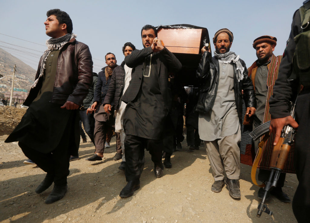 Afghan men carry the coffin of one of the victims of the Jan. 27 car bomb attack in Kabul. Photo by Omar Sobhani/Reuters