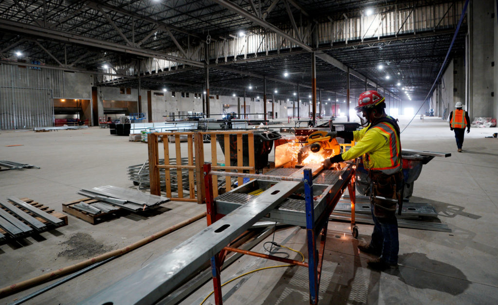 A worker cuts a metal stud in the convention center part of the Gaylord Rockies Resort & Convention Center under const...