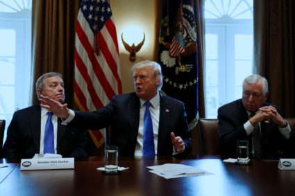 U.S. President Donald Trump, flanked by U.S. Senator Dick Durbin (D-IL) and Representative Steny Hoyer (D-MD), holds a bipartisan meeting with legislators on immigration reform at the White House in Washington, U.S. January 9, 2018. REUTERS/Jonathan Ernst