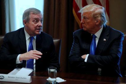 U.S. President Donald Trump, flanked by U.S. Senator Dick Durbin (D-IL), listens during a bipartisan meeting with legislators on immigration reform at the White House in Washington, U.S. January 9, 2018. In a follow-up bipartisan meeting held on January 11, Trump questioned why the United States would want to have immigrants from Haiti and African nations, referring to some as "shithole countries," according to two sources familiar with the comments. REUTERS/Jonathan Ernst/Files - RC14B2A9DAC0