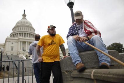 U.S. Army veterans Peter Marshall Bland (C) and James Taylor (R) of Fort Hood, Texas, end a day of protest with a group from the "Million Vet March on the Memorials", rallying against the closure of the U.S. National World War Two Memorial due to the current U.S. government shutdown, on the west front of the U.S. Capitol in Washington, October 13, 2013. Senate Majority Harry Reid said Sunday that he was engaged in negotiations with Republican Minority Leader Mitch McConnell and was "confident" they could resolve the fiscal crisis confronting Washington. REUTERS/Jonathan Ernst (UNITED STATES - Tags: POLITICS BUSINESS EMPLOYMENT CIVIL UNREST) - GM1E9AE0ACD01