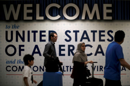 FILE PHOTO: International passengers arrive at Washington Dulles International Airport after the U.S. Supreme Court granted parts of the Trump administration's emergency request to put its travel ban into effect later in the week pending further judicial review, in Dulles, Virginia, U.S., June 26, 2017. REUTERS/James Lawler Duggan/Files - RC1526C4F2E0
