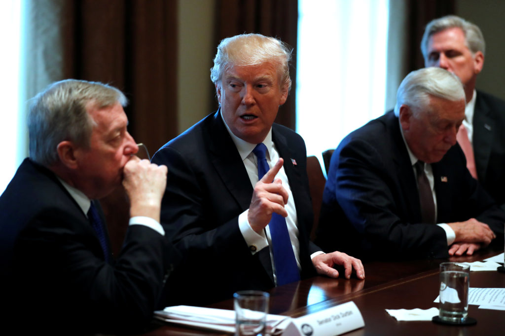 U.S. President Donald Trump, flanked by U.S. Senator Dick Durbin (D-IL), Representative Steny Hoyer (D-MD) and House Major...