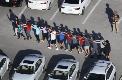 PARKLAND, FL - FEBRUARY 14: People are brought out of the Marjory Stoneman Douglas High School after a shooting at the school that reportedly killed and injured multiple people on February 14, 2018 in Parkland, Florida. Numerous law enforcement officials continue to investigate the scene. (Photo by Joe Raedle/Getty Images)