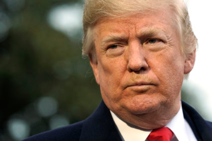 U.S. President Donald Trump listens to question from the media on South Lawn of the White House in Washington, U.S., before his departure to visit the FBI Academy in Quantico, Virginia, U.S. December 15, 2017. REUTERS/Yuri Gripas - RC1EC0B10030