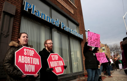 Anti-abortion activists rally next to supporters of Planned Parenthood outside a Planned Parenthood clinic in Detroit, Michigan, on Feb. 11, 2017. Now, Iowa Gov. Kim Reynolds said she plans to sign a six-week abortion ban into law that would be the strictest abortion regulation in the nation. Photo by Rebecca Cook/Reuters
