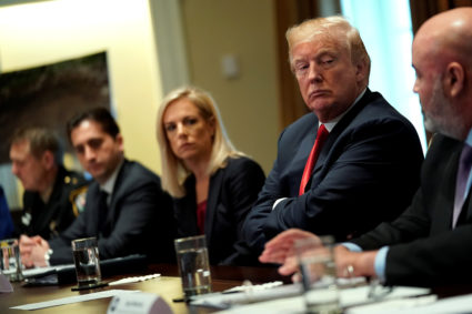 U.S. President Donald Trump, flanked by Secretary of Homeland Security Kirstjen Nielsen (C), meets with members of Congress and U.S. law enforcement about crime and immigration issues, specifically the MS-13 gang, at the White House in Washington, U.S. February 6, 2018. REUTERS/Jonathan Ernst - RC176E856DF0