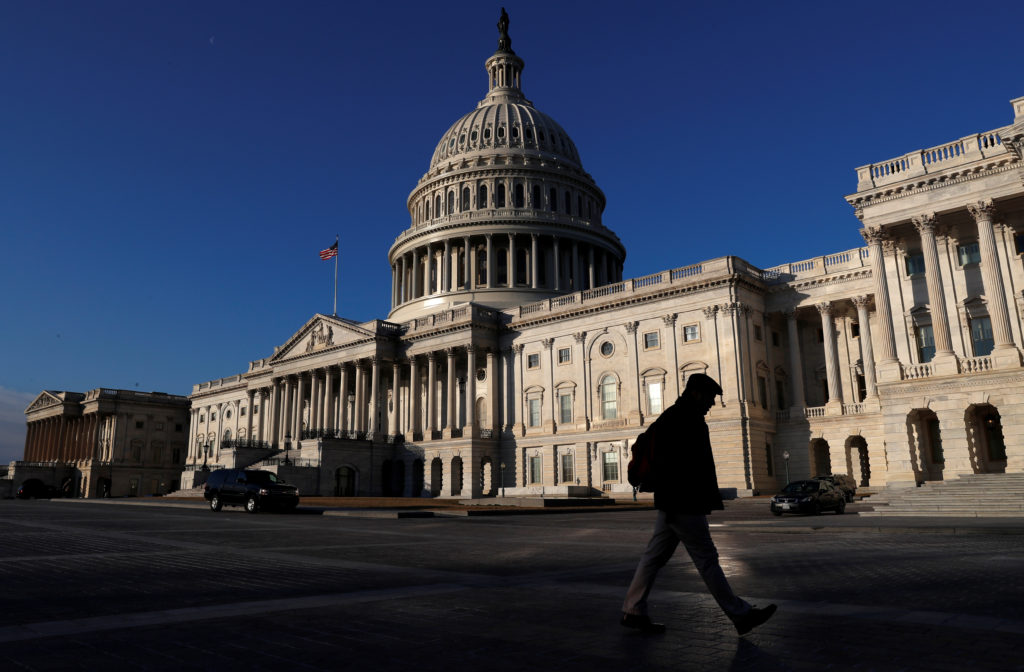 People walk by the U.S. Capitol building in Washington, D.C. Photo by Leah Millis/Reuters