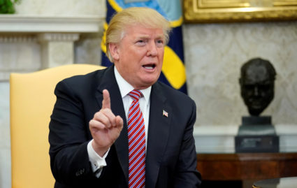 U.S. President Donald Trump declares his opposition to domestic violence during a working session regarding the Opportunity Zones provided by tax reform in the Oval Office of the White House in Washington, U.S., February 14, 2018. REUTERS/Joshua Roberts - RC11BECC88B0
