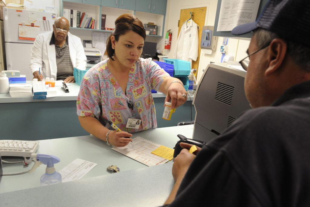 Pharmacy tech Maria Santoyo (C) works in Clinica Sierra Vista's Lamont Community Health center in Bakersfield, California....