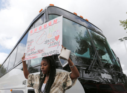 Tyra Hemans, 19, a senior at Marjory Stoneman Douglas High School students board buses to travel to Tallahassee, Florida to meet with legislators in Coral Springs, Florida, U.S. February 20, 2018. REUTERS/Joe Skipper - RC1570BAF070