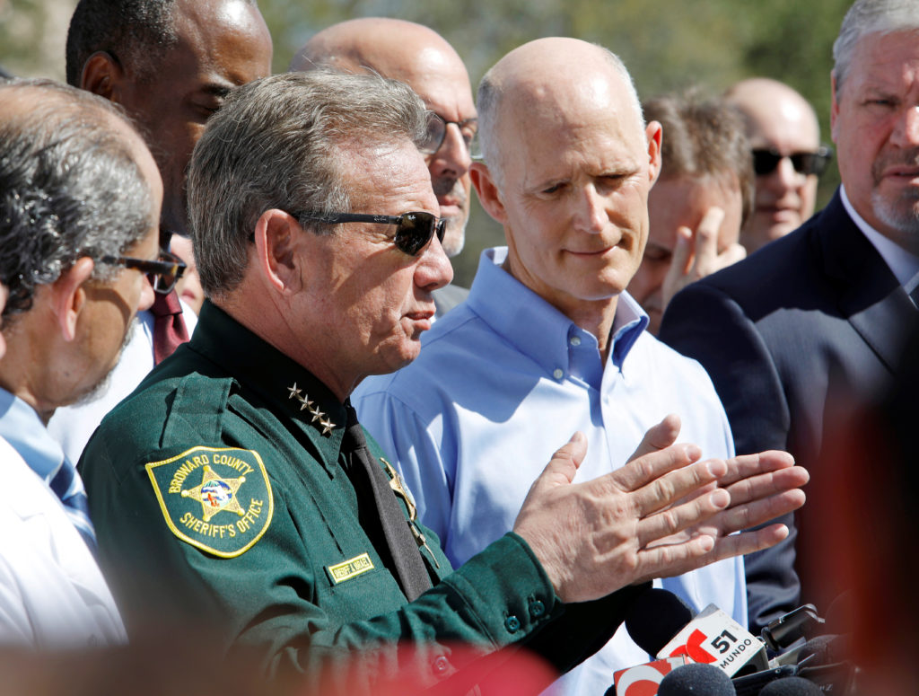 Broward County Sheriff Scott Israel speaks to the media while Florida Governor Rick Scott listens outside Marjory Stoneman...