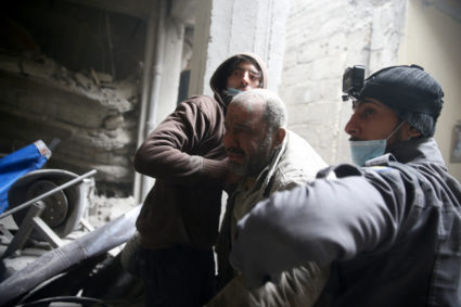 Civil defence help a man from a shelter in the besieged town of Douma in eastern Ghouta in Damascus, Syria, February 22, 2018. REUTERS/Bassam Khabieh - RC13BD6E3DD0