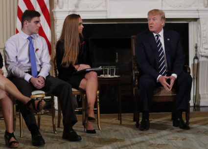 Marjory Stoneman Douglas High School shooting surviving students Jonathan Blank (L) and Julia Cordover (C) listen to U.S. President Donald Trump speak during a listening session with high school students and teachers to discuss school safety and guns at the White House in Washington, U.S., February 21, 2018 REUTERS/Jonathan Ernst - HP1EE2L1OFLHP