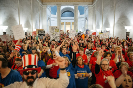 Striking school workers held signs and chanted inside the West Virginia Capitol last week in Charleston, West Virginia. Photo by Scott Heins/Bloomberg via Getty Images