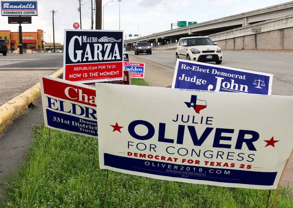 Political campaign signs stand outside a polling station in Austin, Texas, United States March 5, 2018 ahead of the first ...